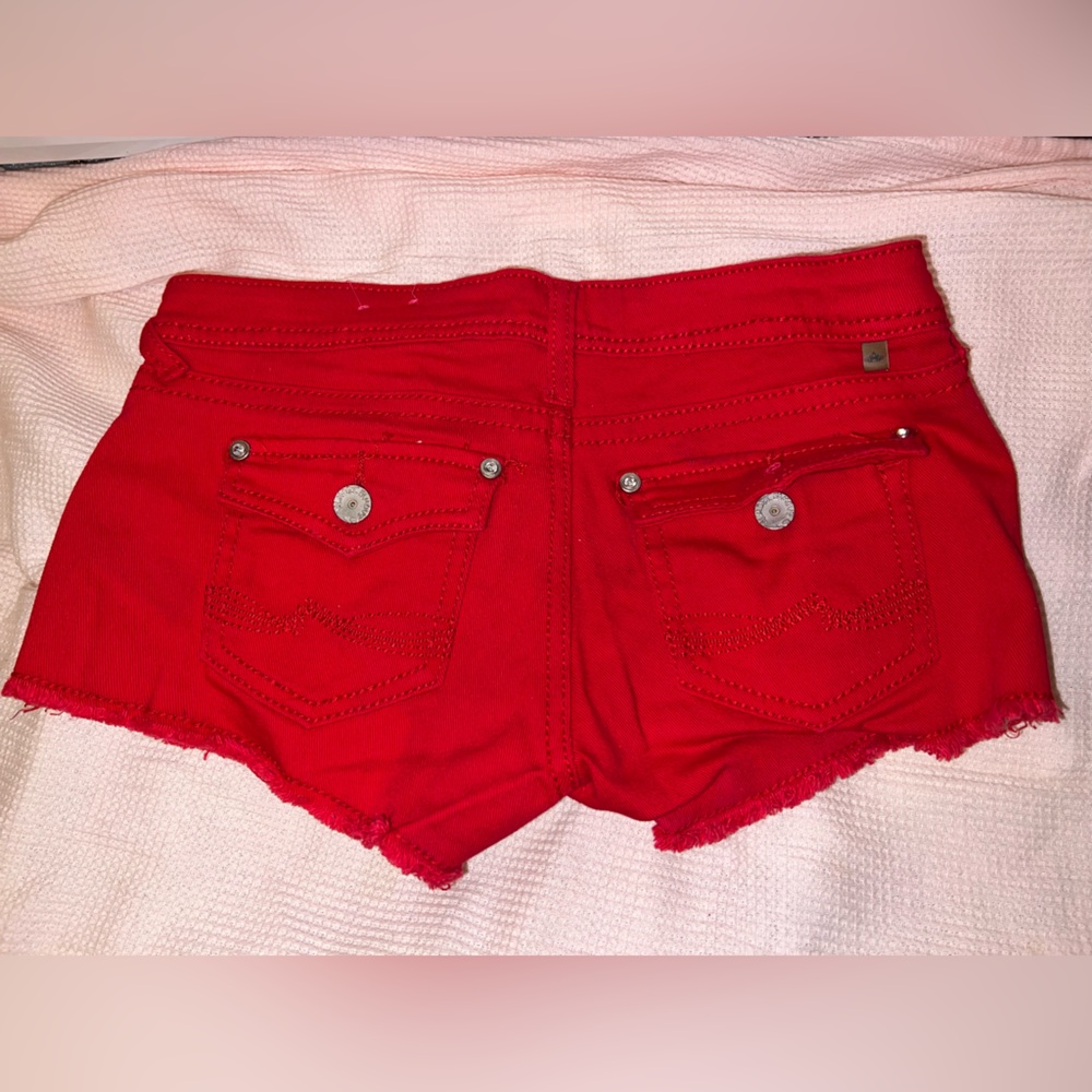 Low waist butt enhancing super stretch fringe jean distressed button rip shorts